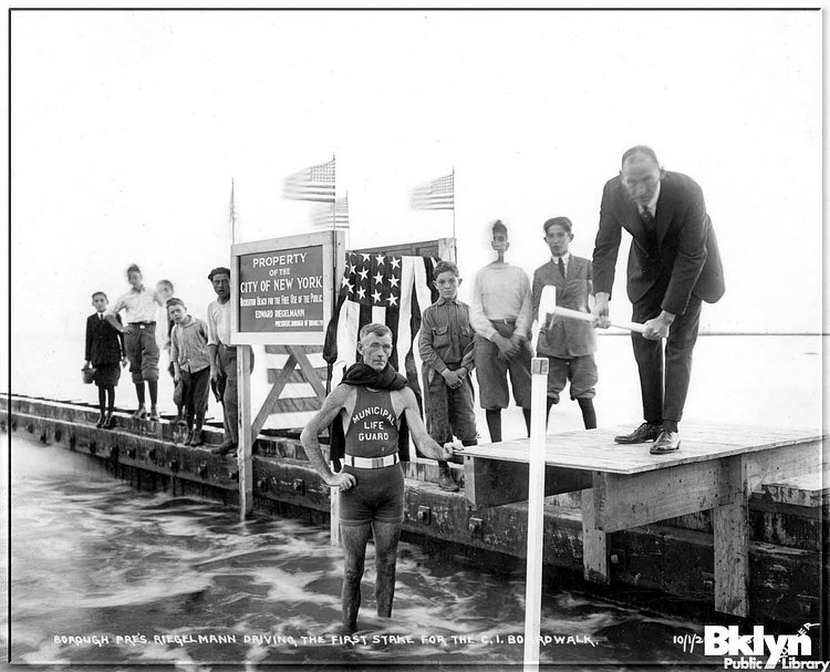 Brooklyn borough president Riegelmann driving the first stake for the Coney Island boardwalk, October 1st, 1921