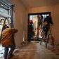 Workers installing a sliding window in the main living area of an apartment.