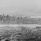 Manhattan Haze | Panorama taken from a flight out of Newark on a hazy day.  Canon 6D with a Canon 70-200mm f/2.8L (mark 1, non-IS). Stitched together with Microsoft ICE.

The original color image had a heavy, almost monochrome, blue cast.  Do you think I should have left the color in?