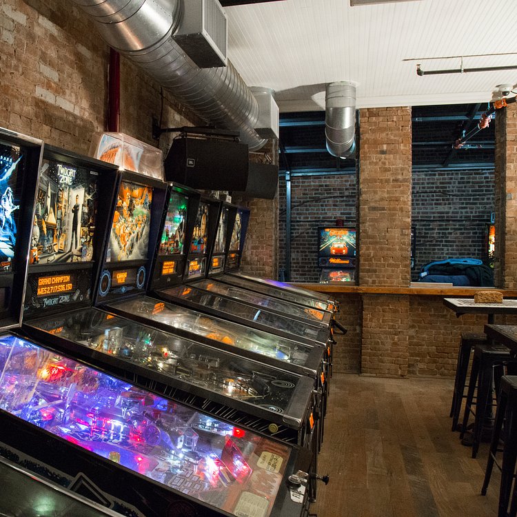A row of pinball machines in the remodeled back room.