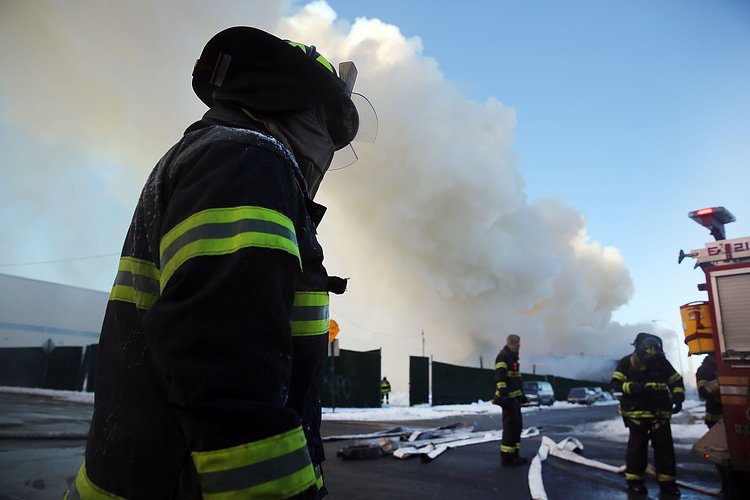 Firefighters continued pouring water on the remains of a 7-alarm fire in a warehouse on the Williamsburg waterfront