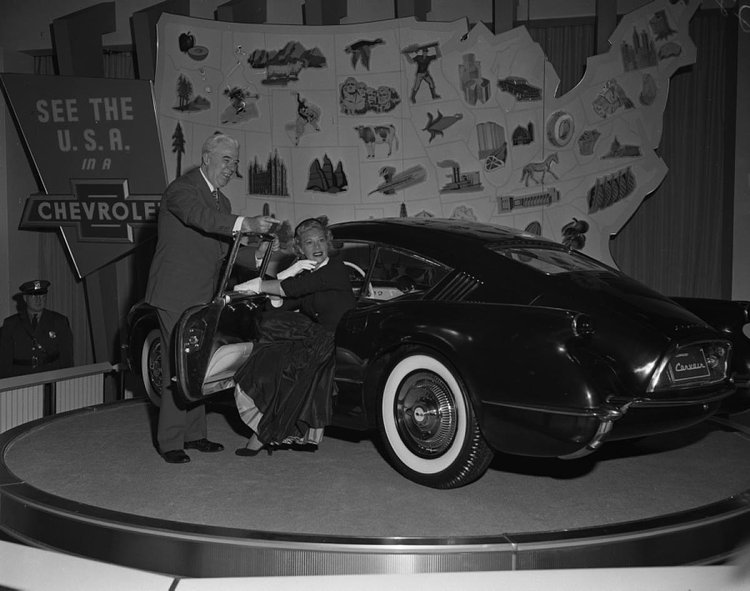 Singer Dinah Shore gets an up close look at the Chevrolet Corvair concept car at the General Motors Motorama exhibition held at the Waldorf.