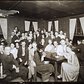Group portrait, indoors, of people gathered at the Garrett Coffee House, circa 1912-1917; photograph by Jessie Tarbox Beals.