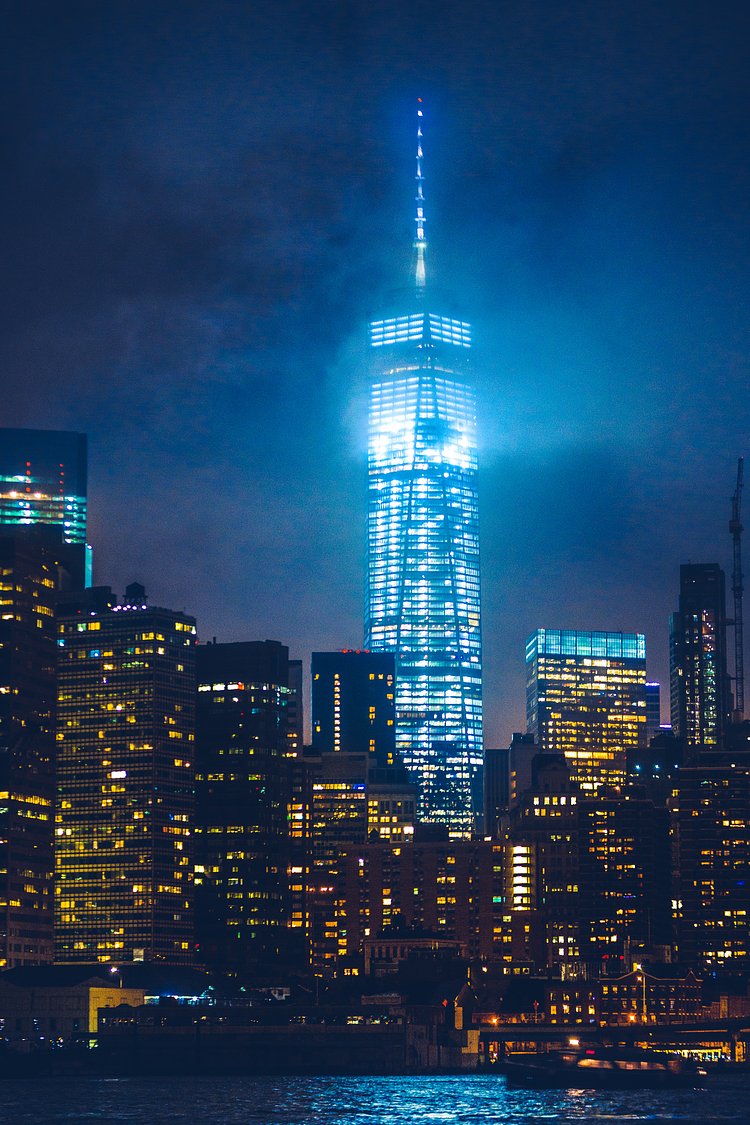 Turris Lucis | Standing on the edge of the East River in Brooklyn, I watched a storm pass over Manhattan. From here you could see One World Trade Center grazing the clouds as its glow illuminated the city sky.