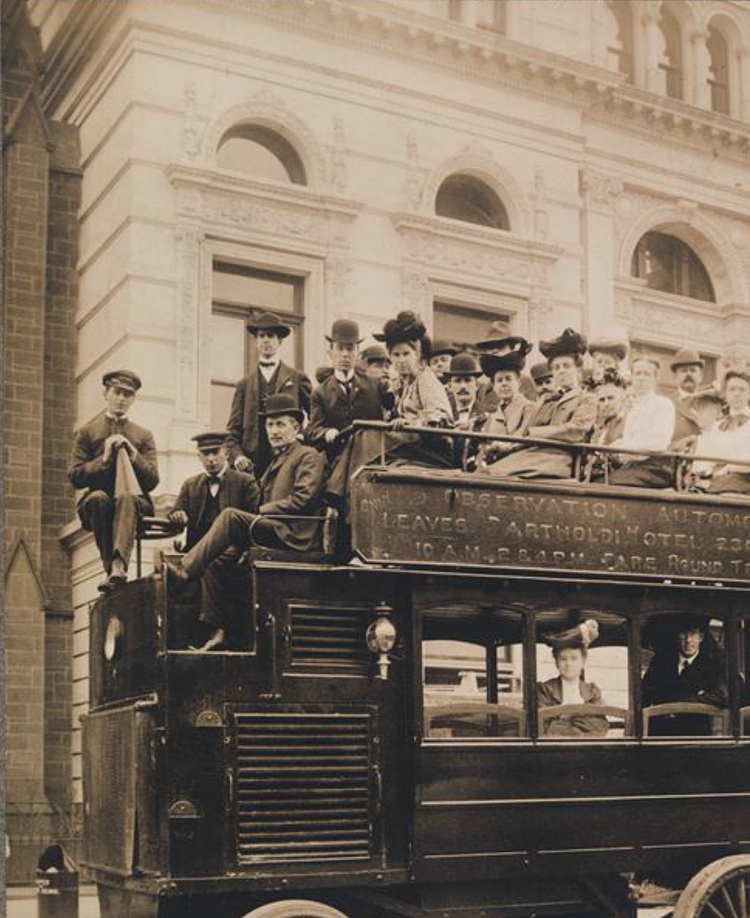 Group portrait of passengers on an observation automobile.