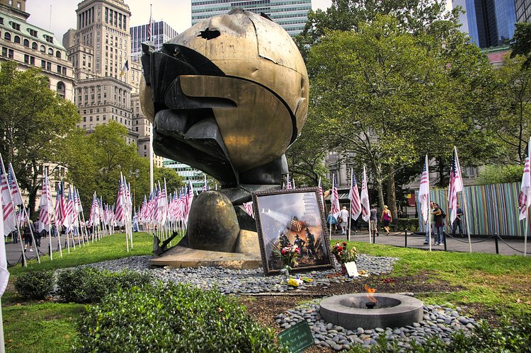 Battery Park - The Sphere |     *  The Sphere 
    * Dedicated March 11, 2002
    * Description: Temporary Installation of artwork salvaged from WTC Disaster Site. The 25’ high sphere stood in the WTC Plaza as a monument to world peace from 1971 to September 11, 2001.
   