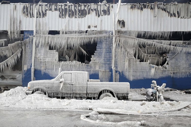 Firefighters continued pouring water on the remains of a 7-alarm fire in a warehouse on the Williamsburg waterfront