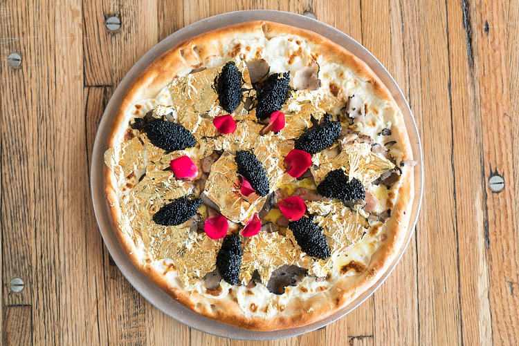 .@Industrykitnyc is serving up a little slice of heaven with its luxury $2K pizza topped with caviar, truffles, and 24-karat gold leaves.
