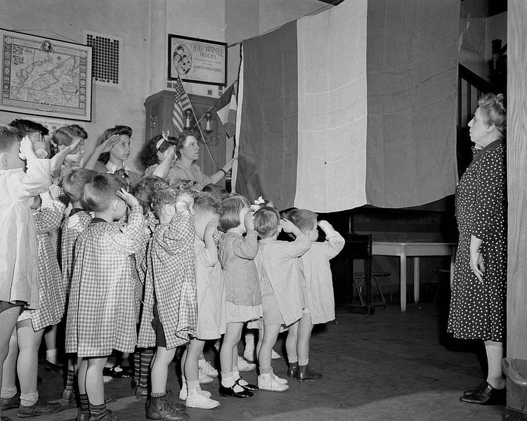 Children salute the French flag at a French school in Manhattan