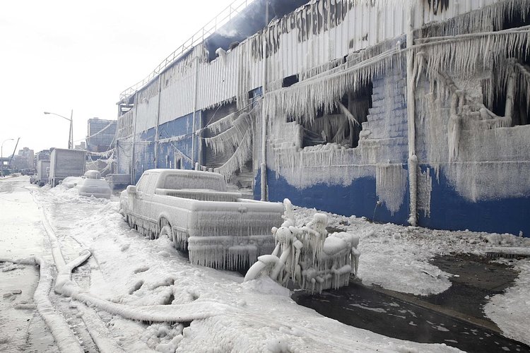 Firefighters continued pouring water on the remains of a 7-alarm fire in a warehouse on the Williamsburg waterfront