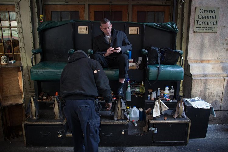 Walt "Shine" White, shines the shoes of Bob Cohen, a trader.