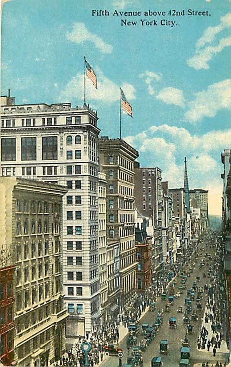 In a similar view also from around 1927, at a higher vantage point, we are looking up Fifth Avenue north from 42nd Street. Vehicular traffic flows both ways as crowds throng the sidewalks. On the west side of the street can be seen the steeple of St. Thomas Episcopal Church. Beyond the church, the last building visible before the southern tip of Central Park is the Plaza Hotel.
