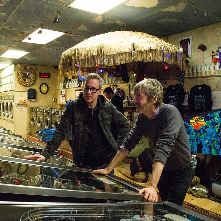 Patrick Ryan and Fred Blair came to the Sunshine Laundromat to play pinball. Located in the Greenpoint section of Brooklyn, the laundromat was recently remodeled to include a 1,000-square-foot arcade with 23 pinball machines, a photo booth and a fortune-telling machine, along with a bar that serves wine and beer.