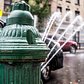 Classic NYC Summer | An open hydrant spraying water on a hot summer day.